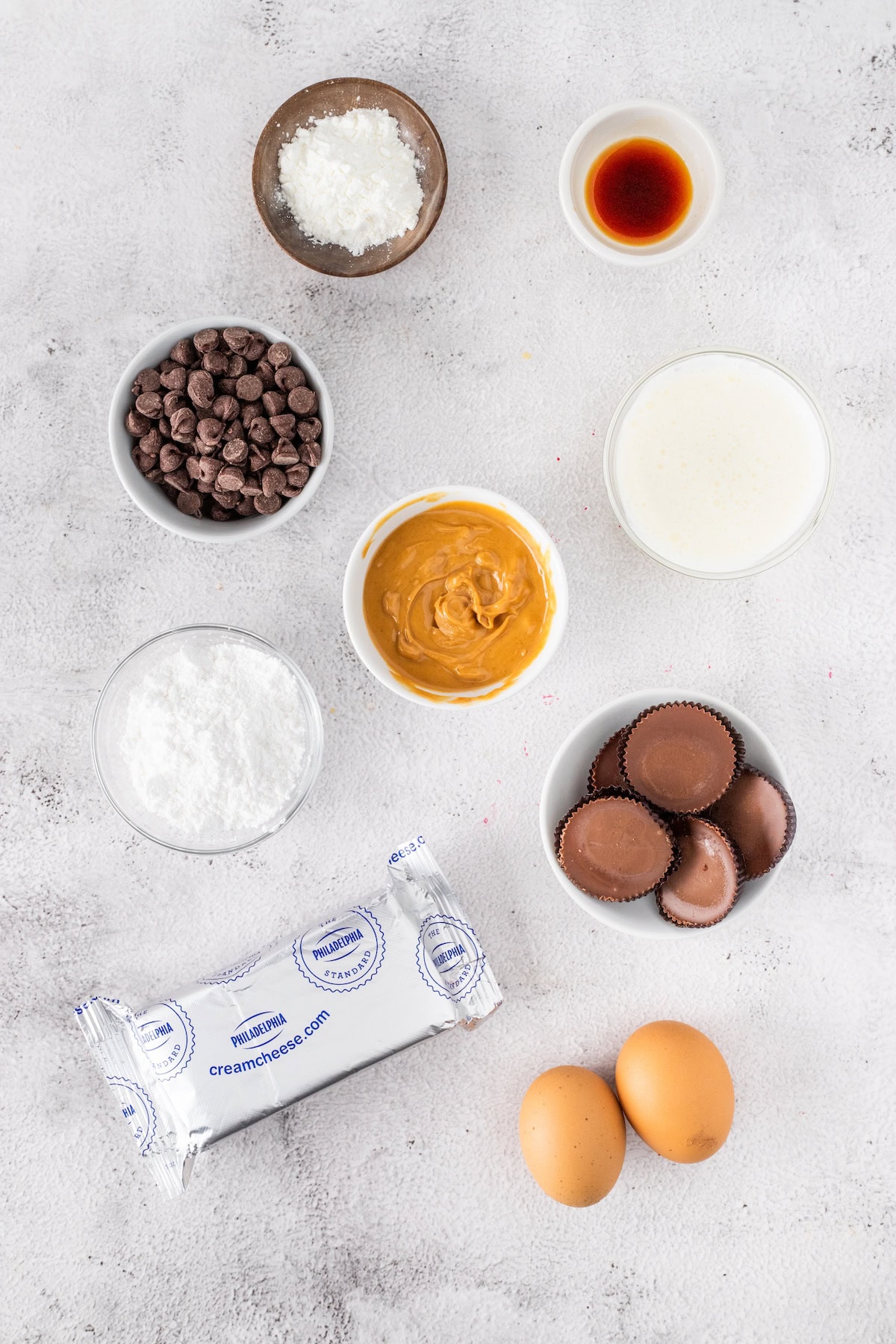 Mini Peanut Butter Cup Cheesecakes ingredients including Reese's peanut butter cups and cream cheese