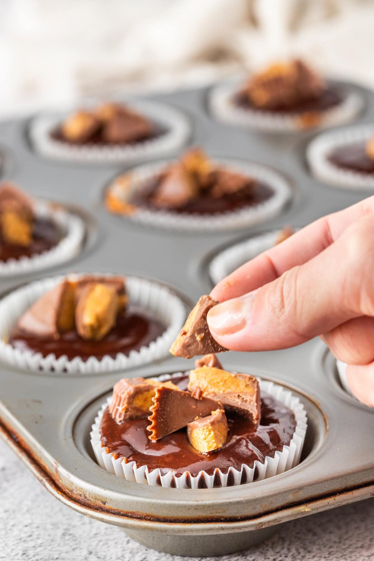 top the chocolate ganache with chopped Reese's peanut butter cups
