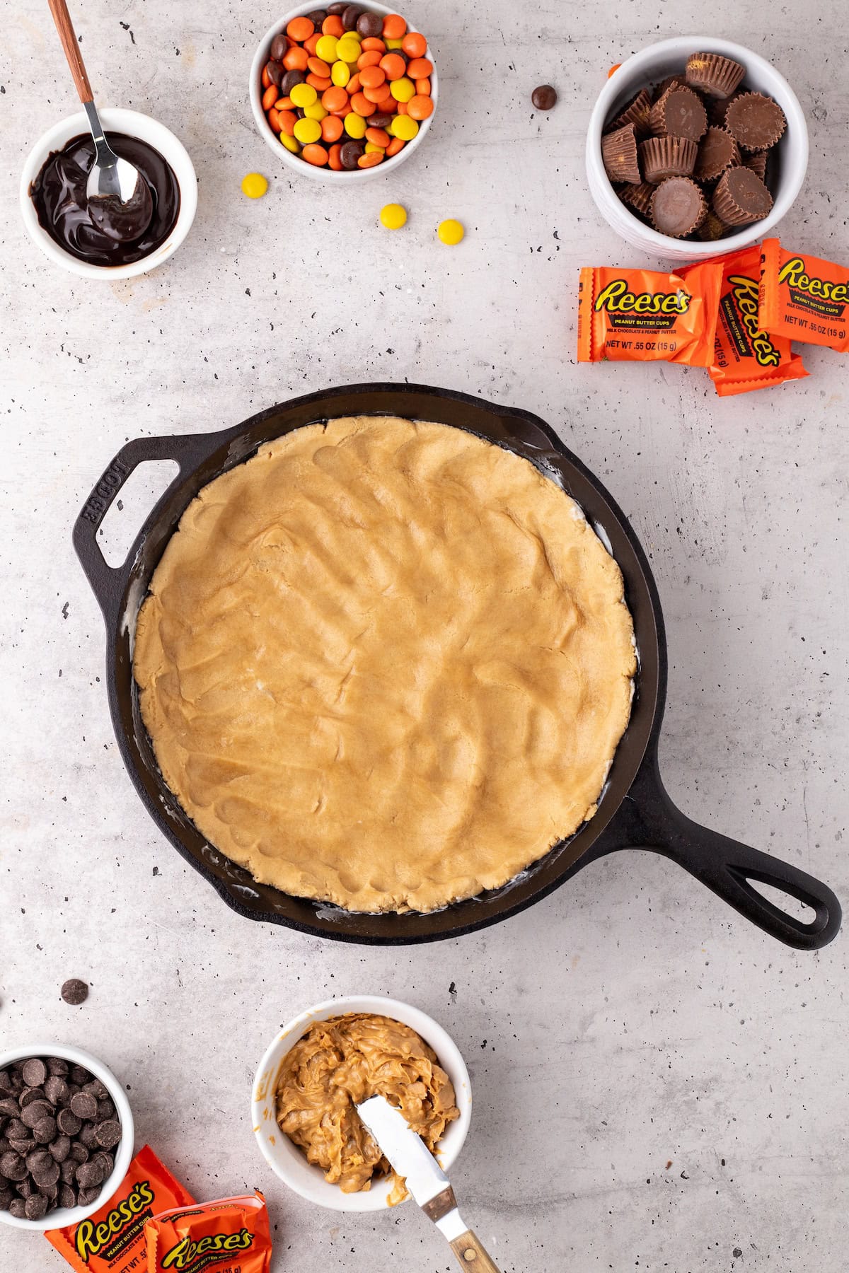 the bottom layer of the cookie cake with the peanut butter cookie dough all pressed into a single sheet