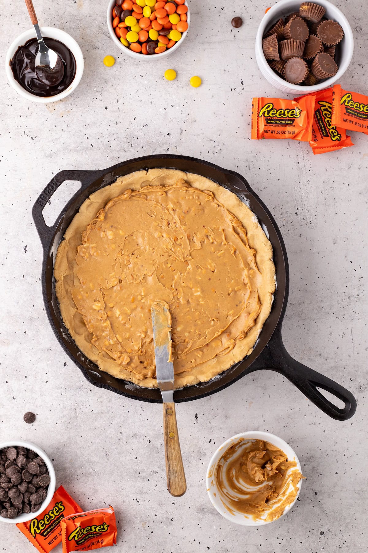 the bottom half of the skillet cookie topped with crunchy peanut butter