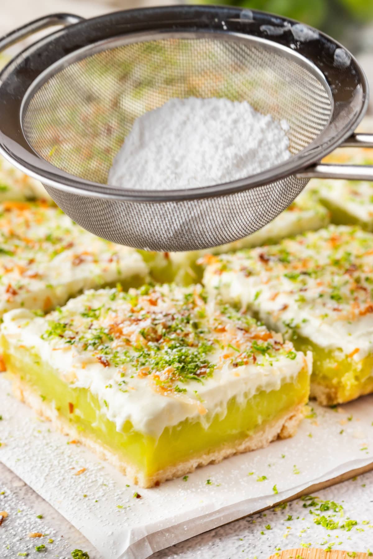 sprinkle the key lime pie bars with powdered sugar