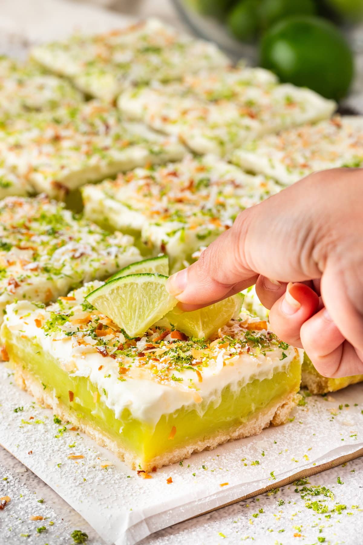 top the key lime pie bars with slices of key limes