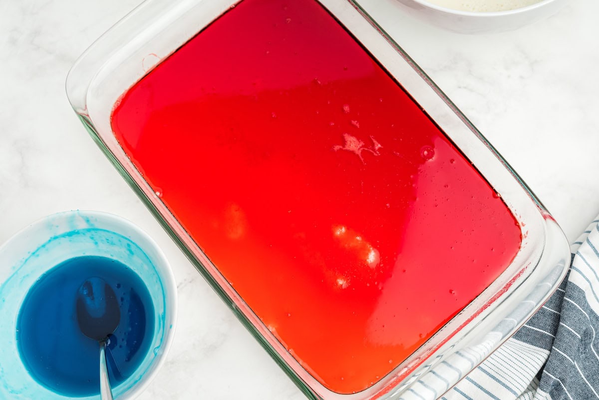 pour red jello over the cooled condensed milk layer
