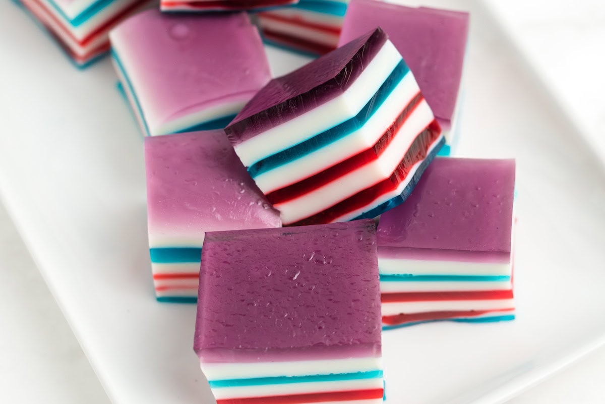 a bunch of cubes of red white and blue layered finger jello