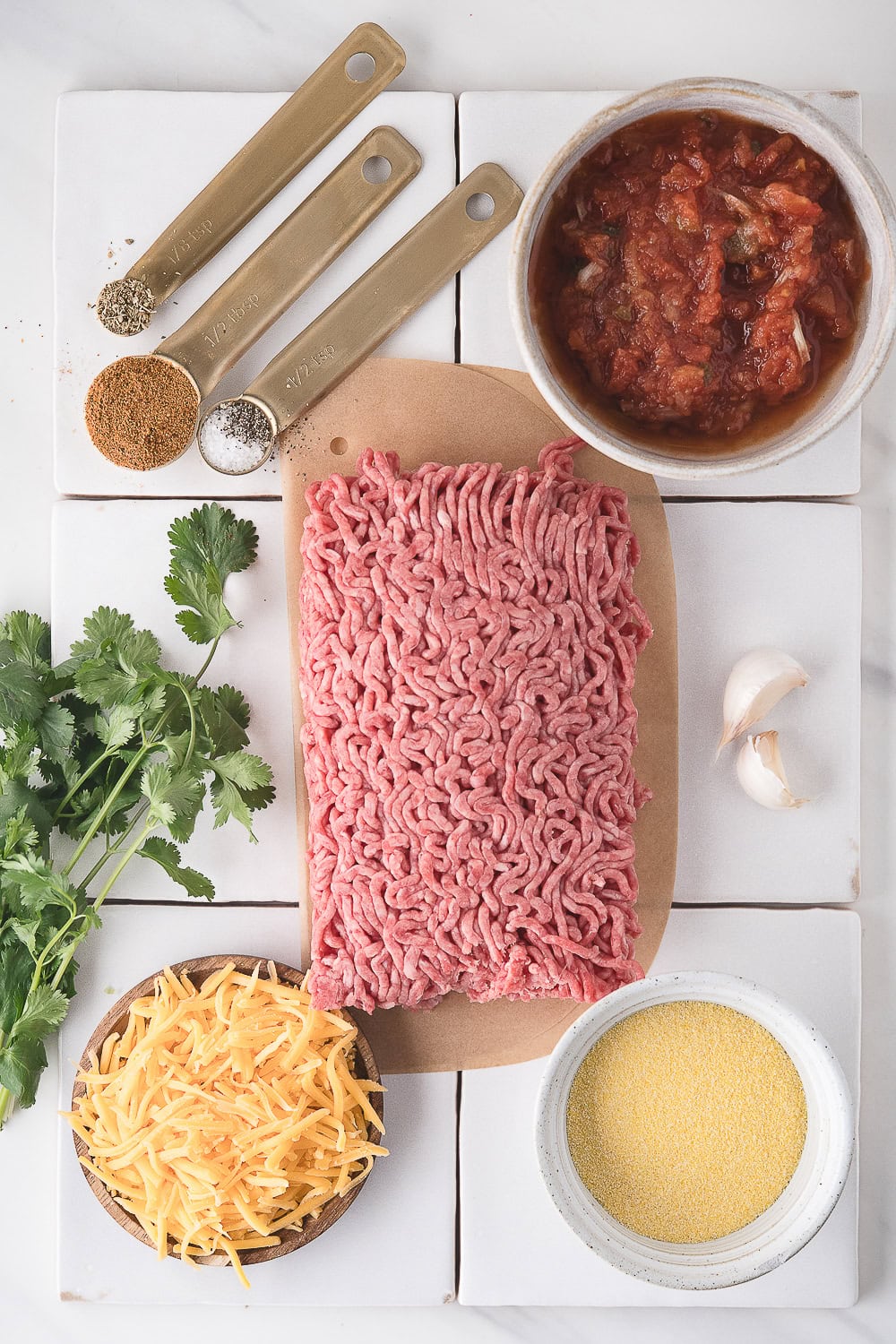 air fryer burgers ingredients including ground beef, salsa, cheddar cheese, and taco seasoning
