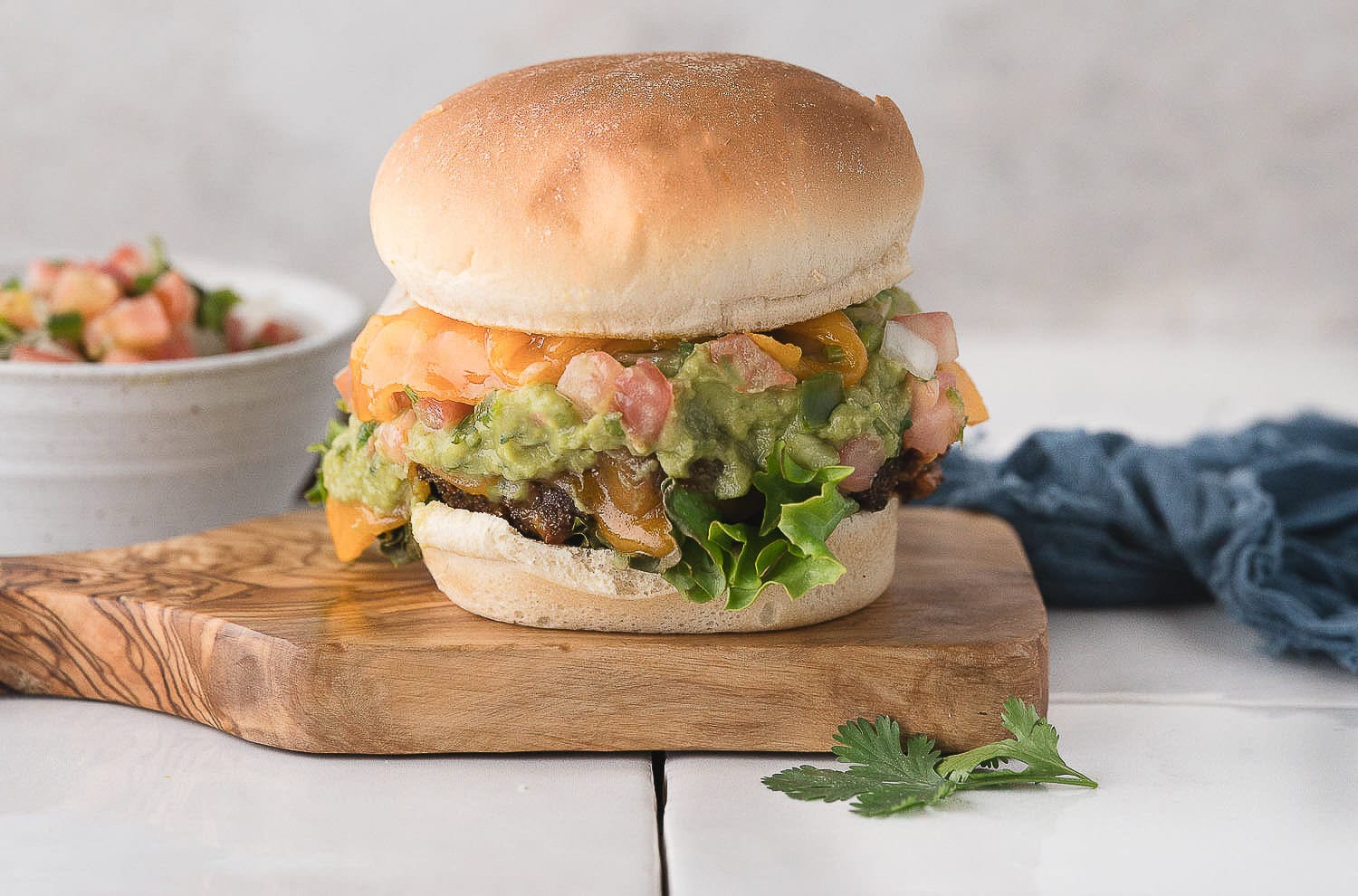 one air fryer burger with taco seasoning and salsa on a cutting board