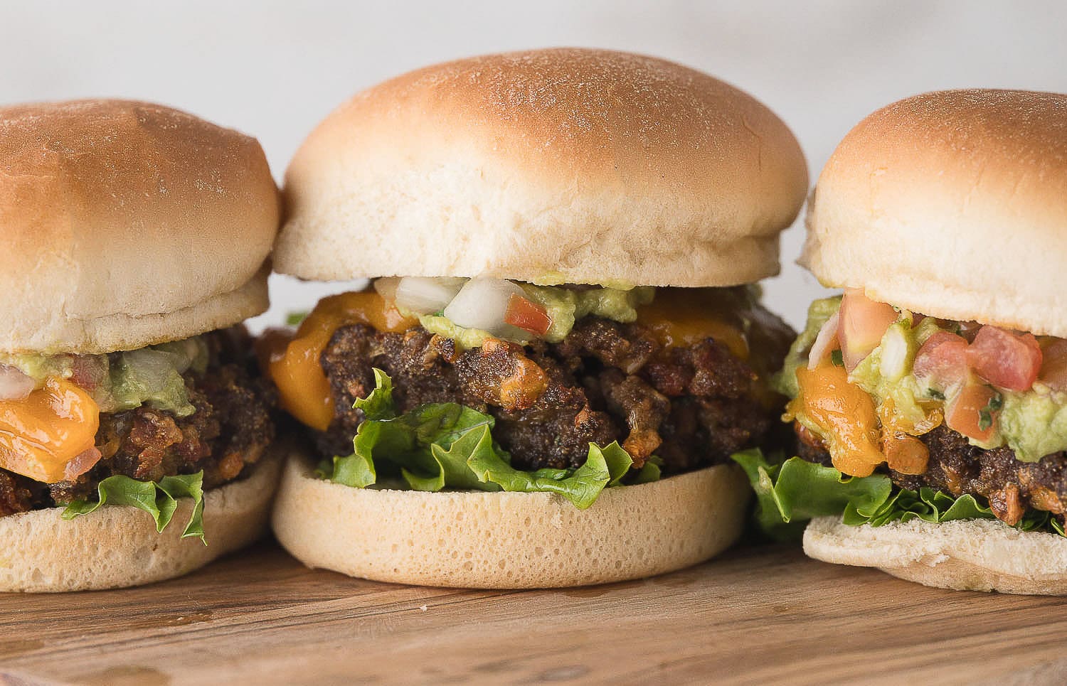 3 air fryer burgers on a cutting board