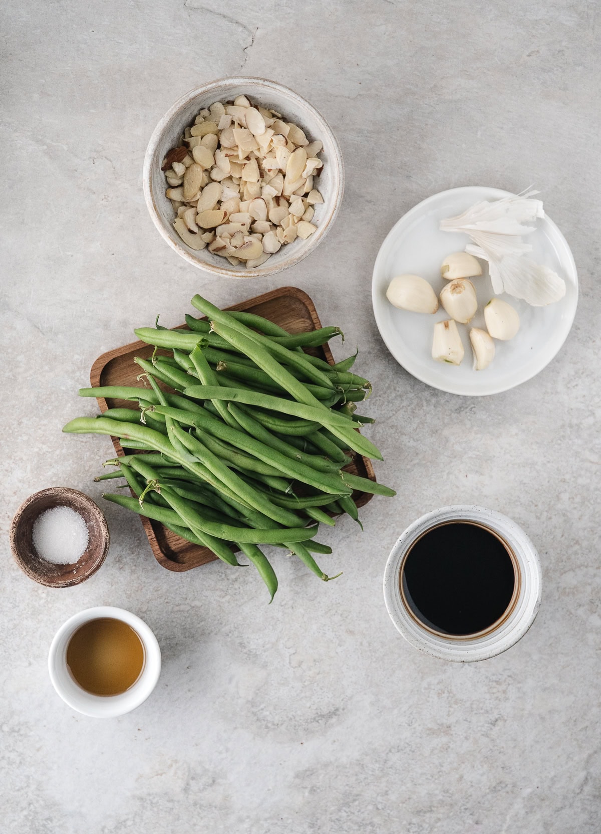 Asian green beans ingredients including soy sauce, garlic, sesame oil, and almonds