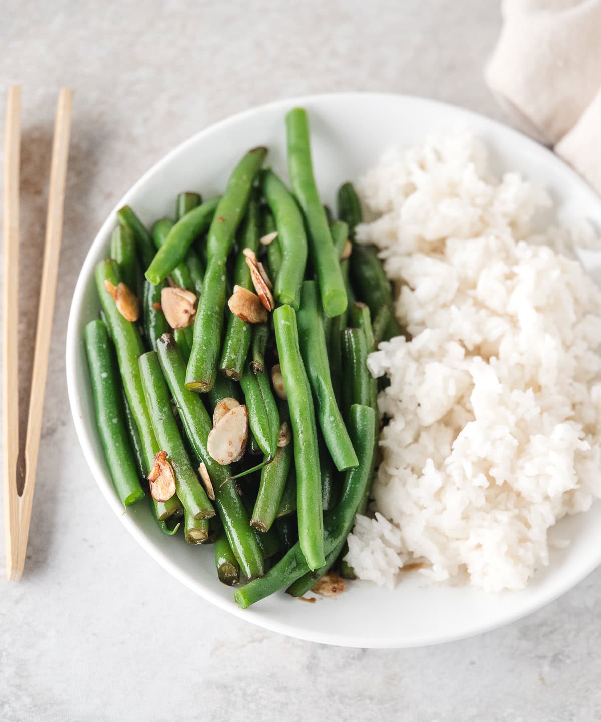 Asian Green Beans with white rice on a white plate