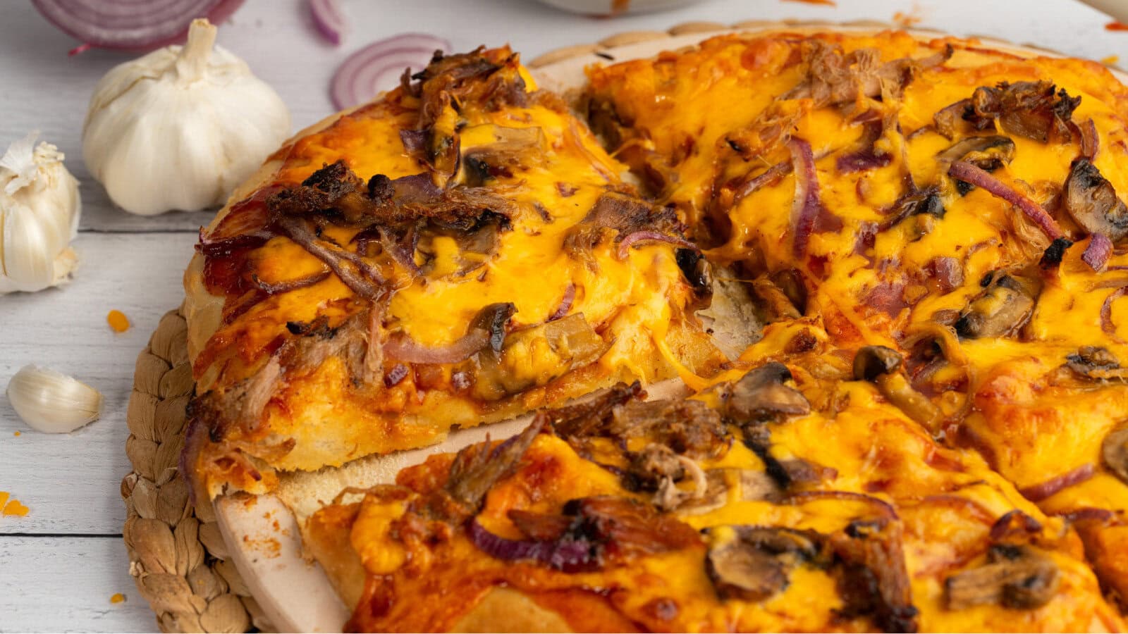 BBQ Pulled Pork Pizza with a wedge cut out