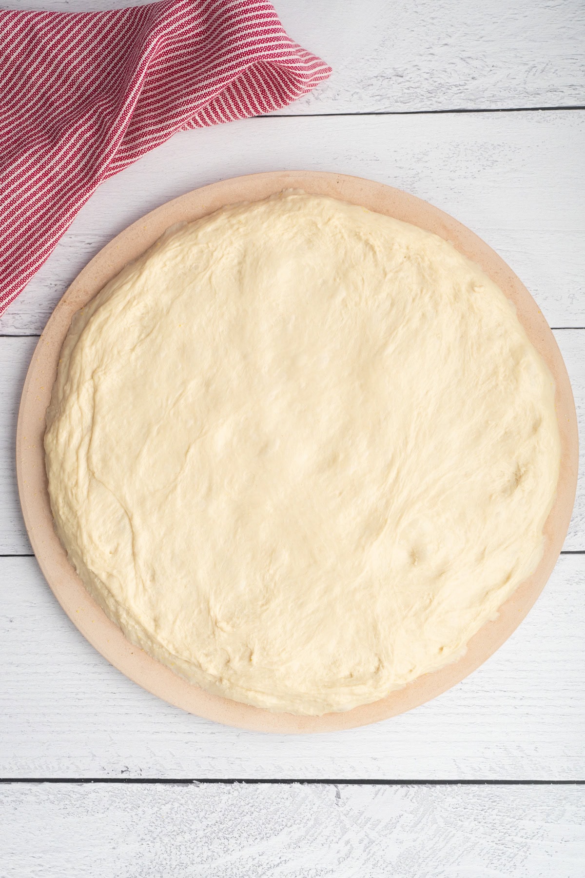 roll the pizza crust on a pizza stone