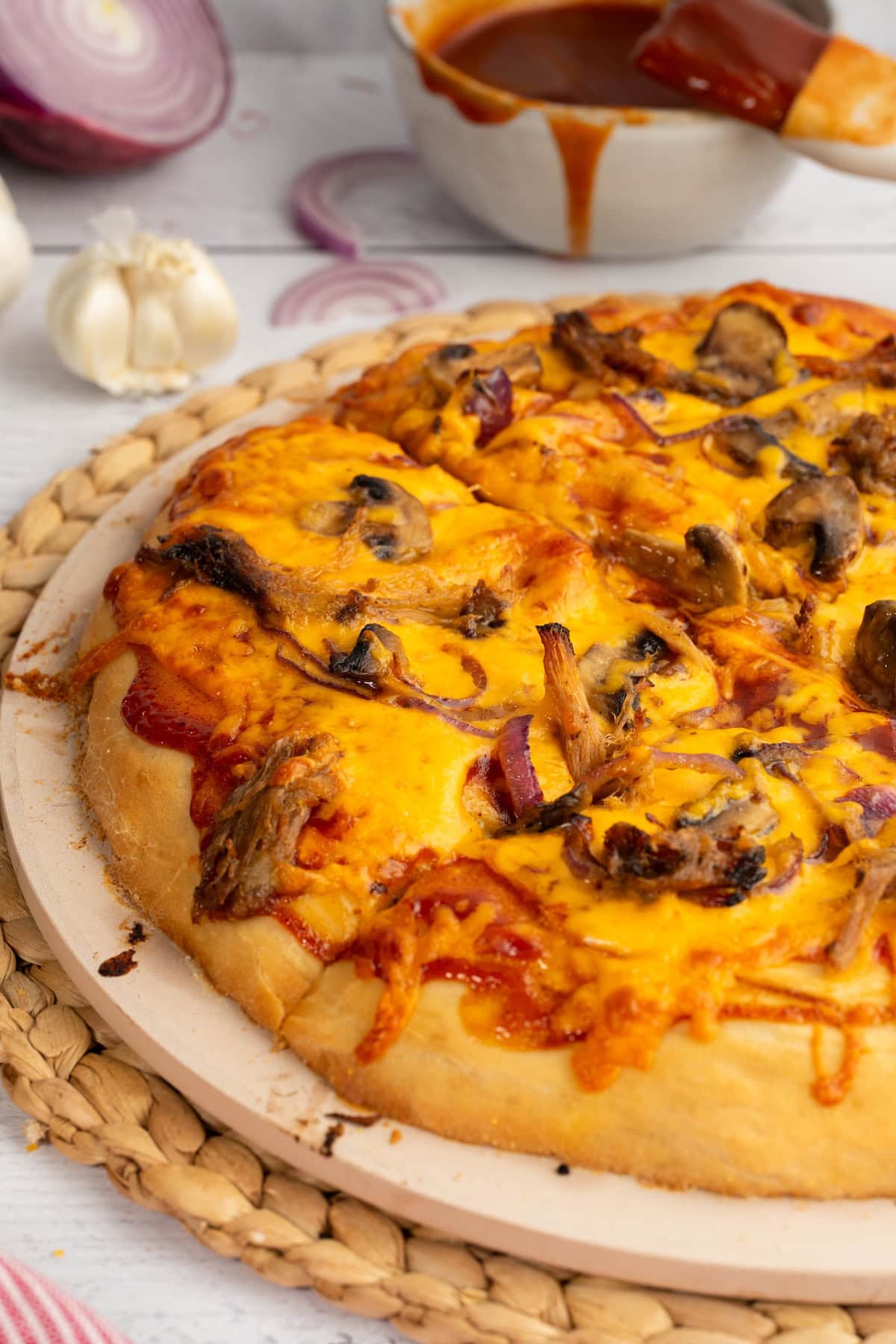 BBQ Pulled Pork Pizza on a pizza stone
