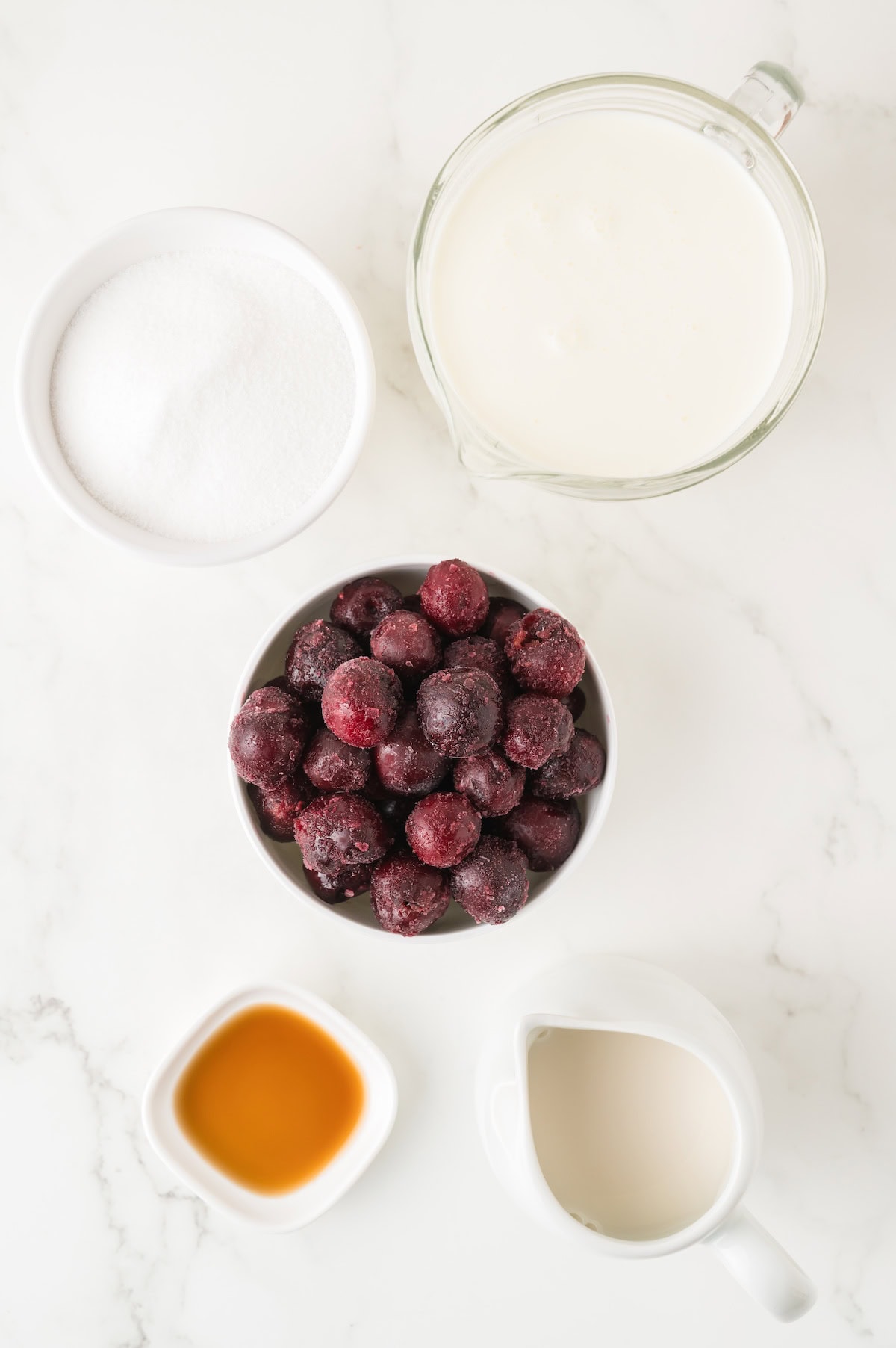 black cherry ice cream ingredients including heavy cream, vanilla, and fresh or frozen cherries