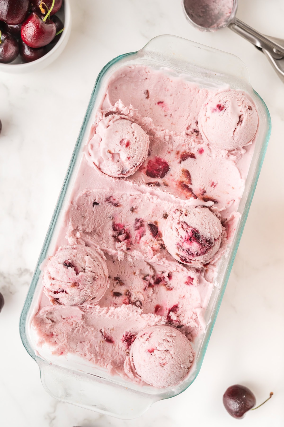 homemade cherry ice cream with five scoops on top