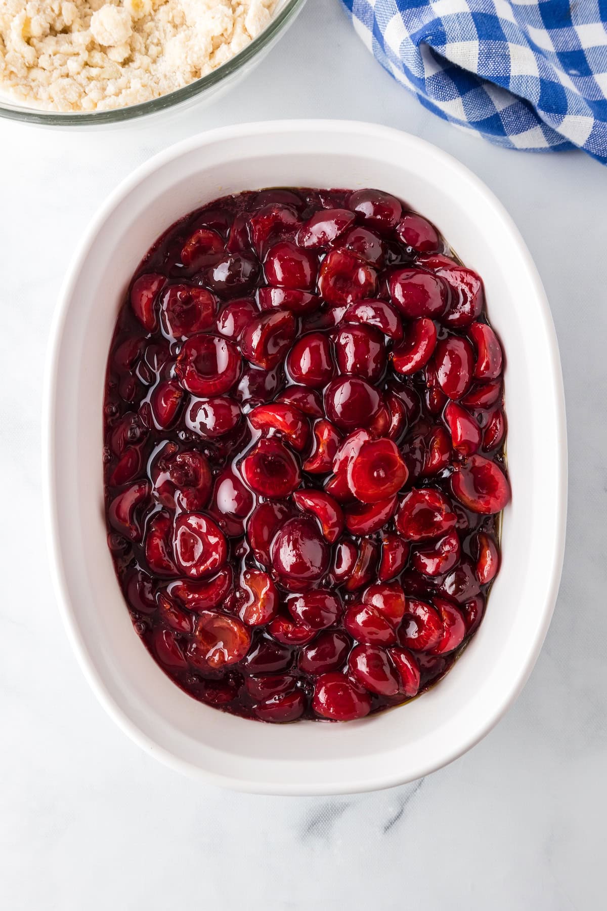 pour the fresh cherry cobbler filling into a baking dish