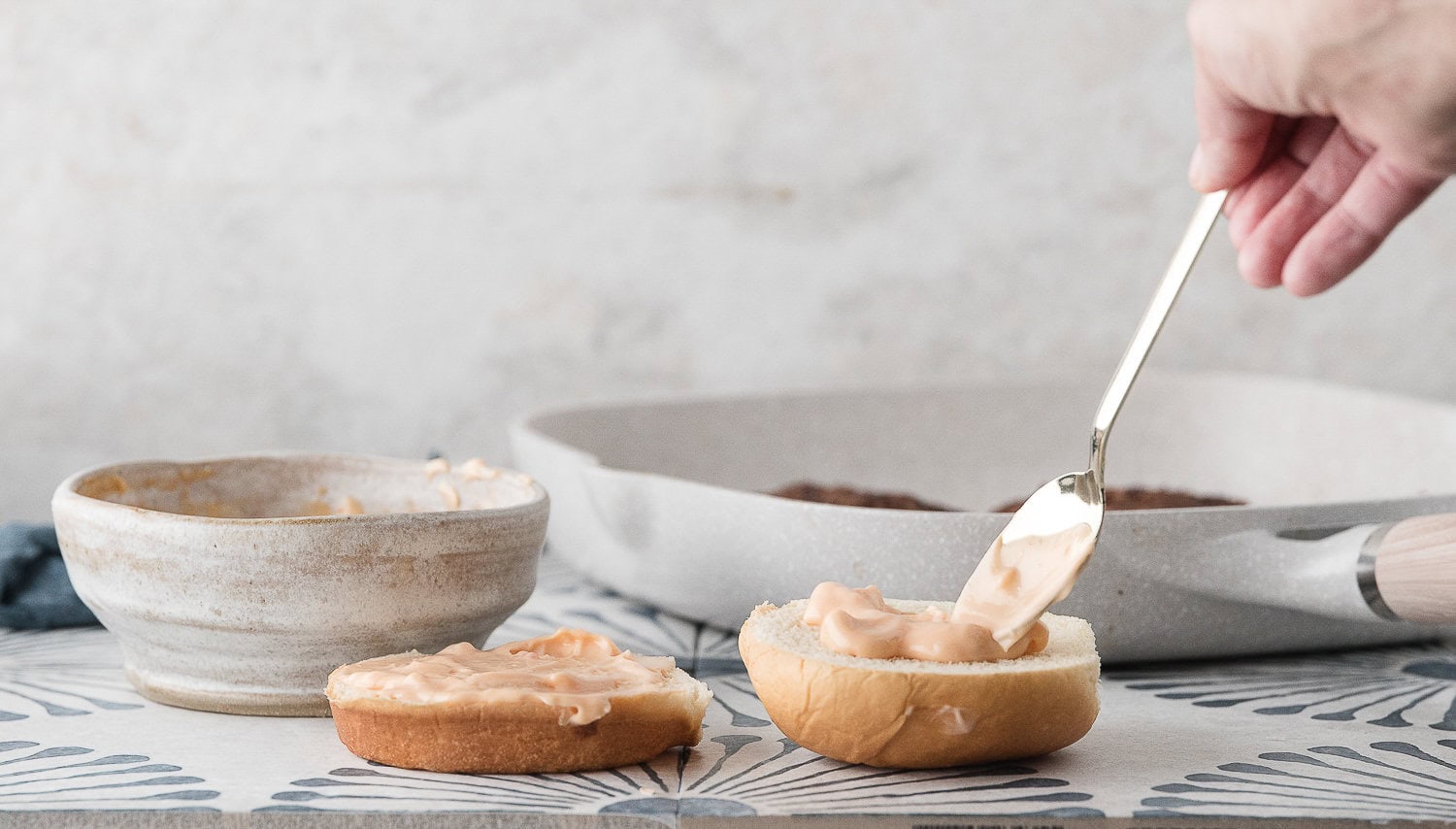 spread sweet and sour mayo on the top and bottom of the buns