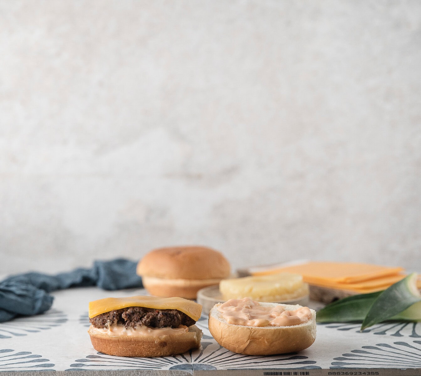place a burger patty on top of the aioli