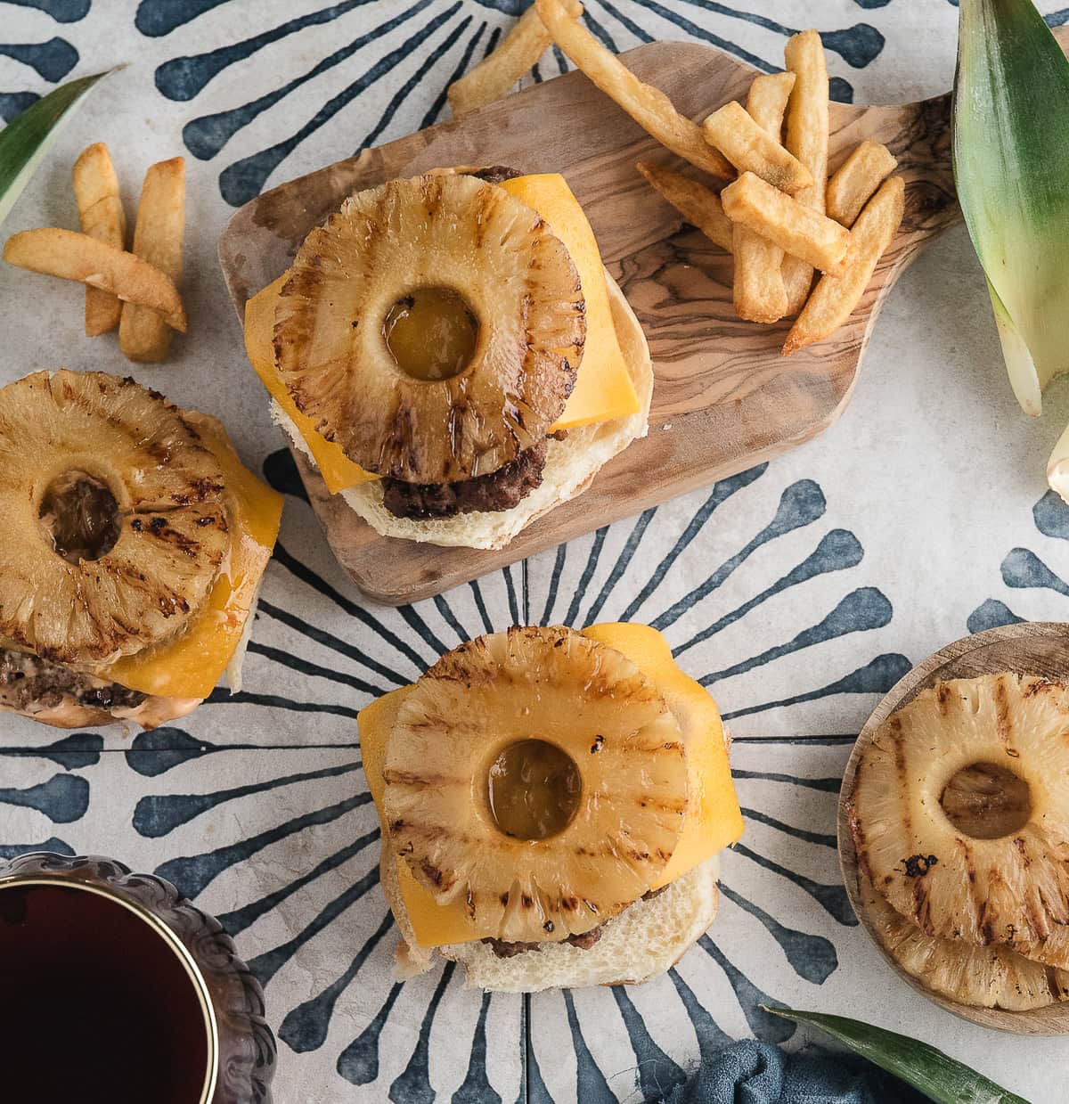 three Hawaiian burgers topped with cheddar and grilled pineapple