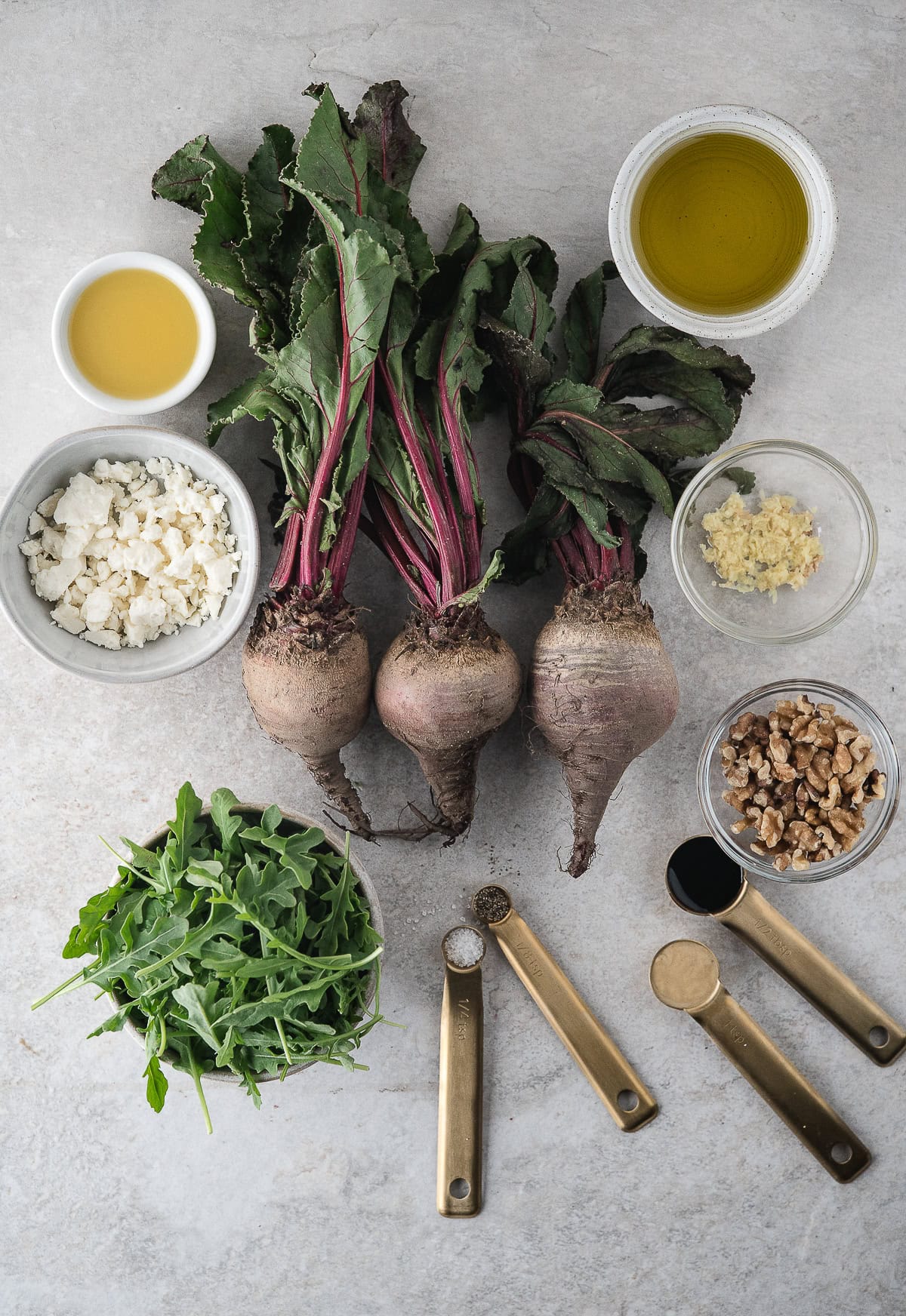 roasted beet salad with feta ingredients including fresh beets, feta cheese, candied walnuts, and fresh arugula