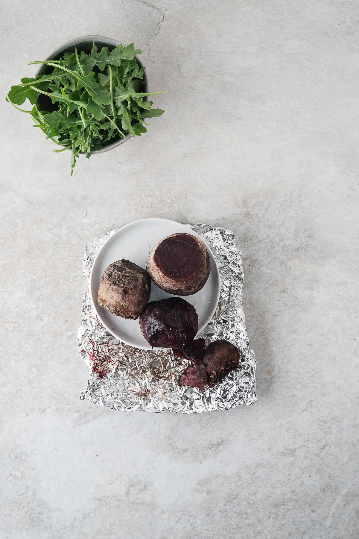 remove the roasted beets from the oven, unwrap, and (when cool) rub the skins off with clean, dry hands or a clean brillo pad