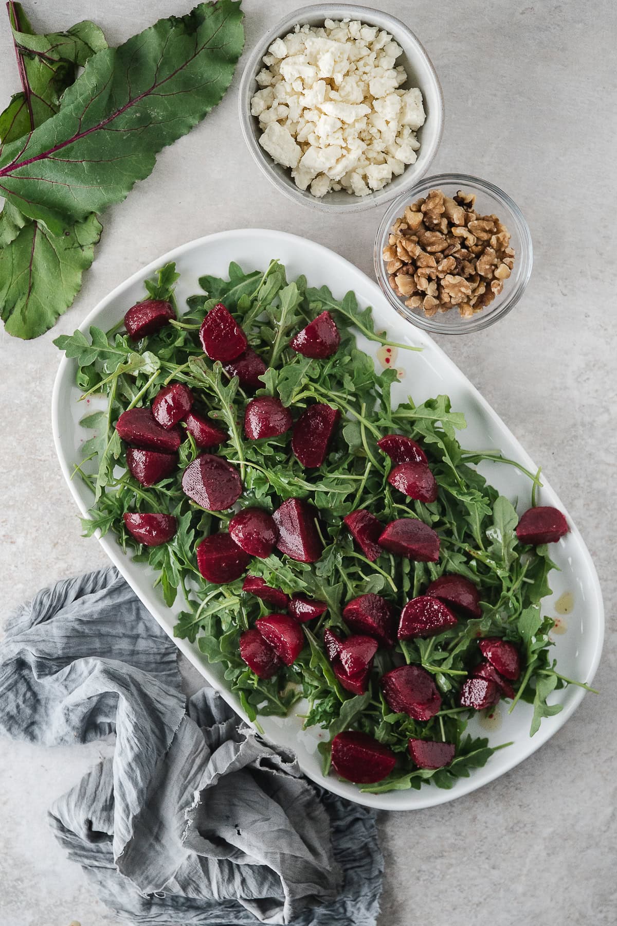 spread the marinated, roasted beets over the arugula
