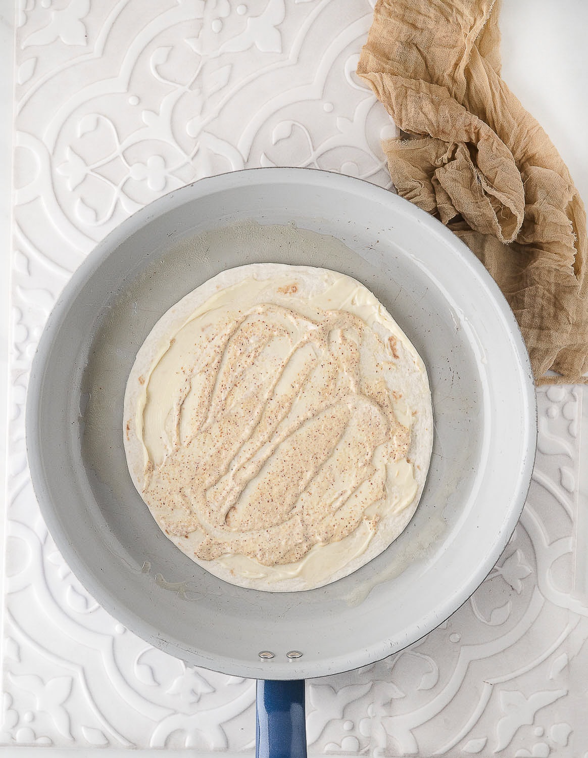 place the tortilla in the melted butter in the skillet
