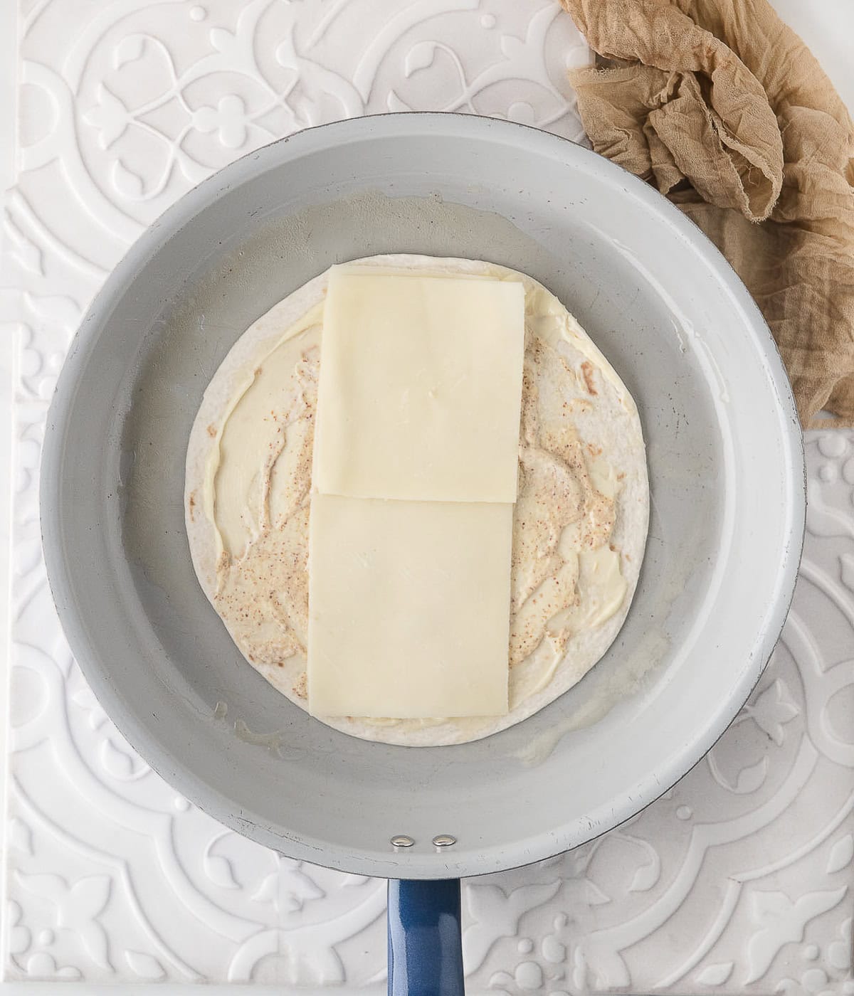 place two slices of cheese in the middle of the warm tortilla