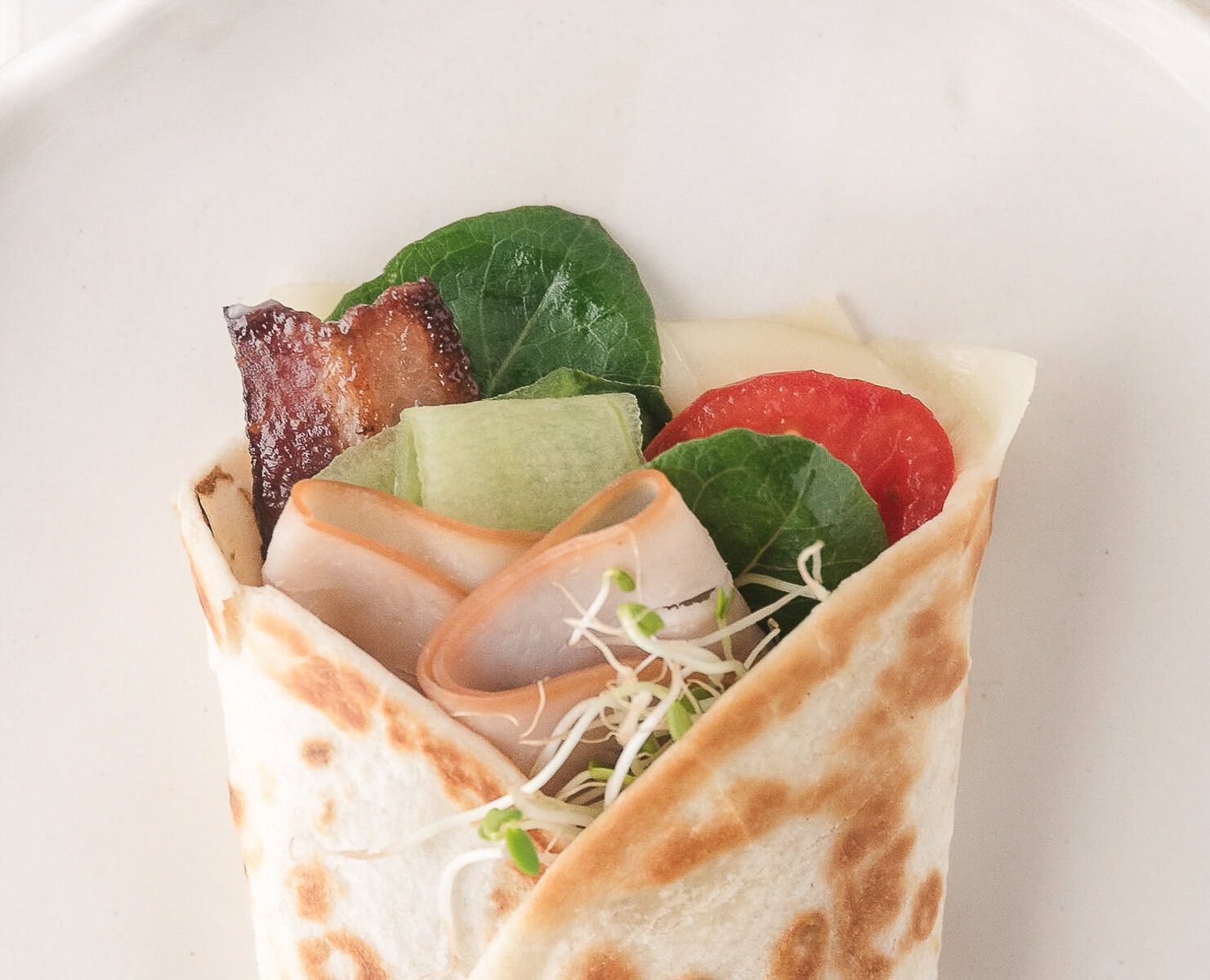 fold the tortilla to make the turkey wrap