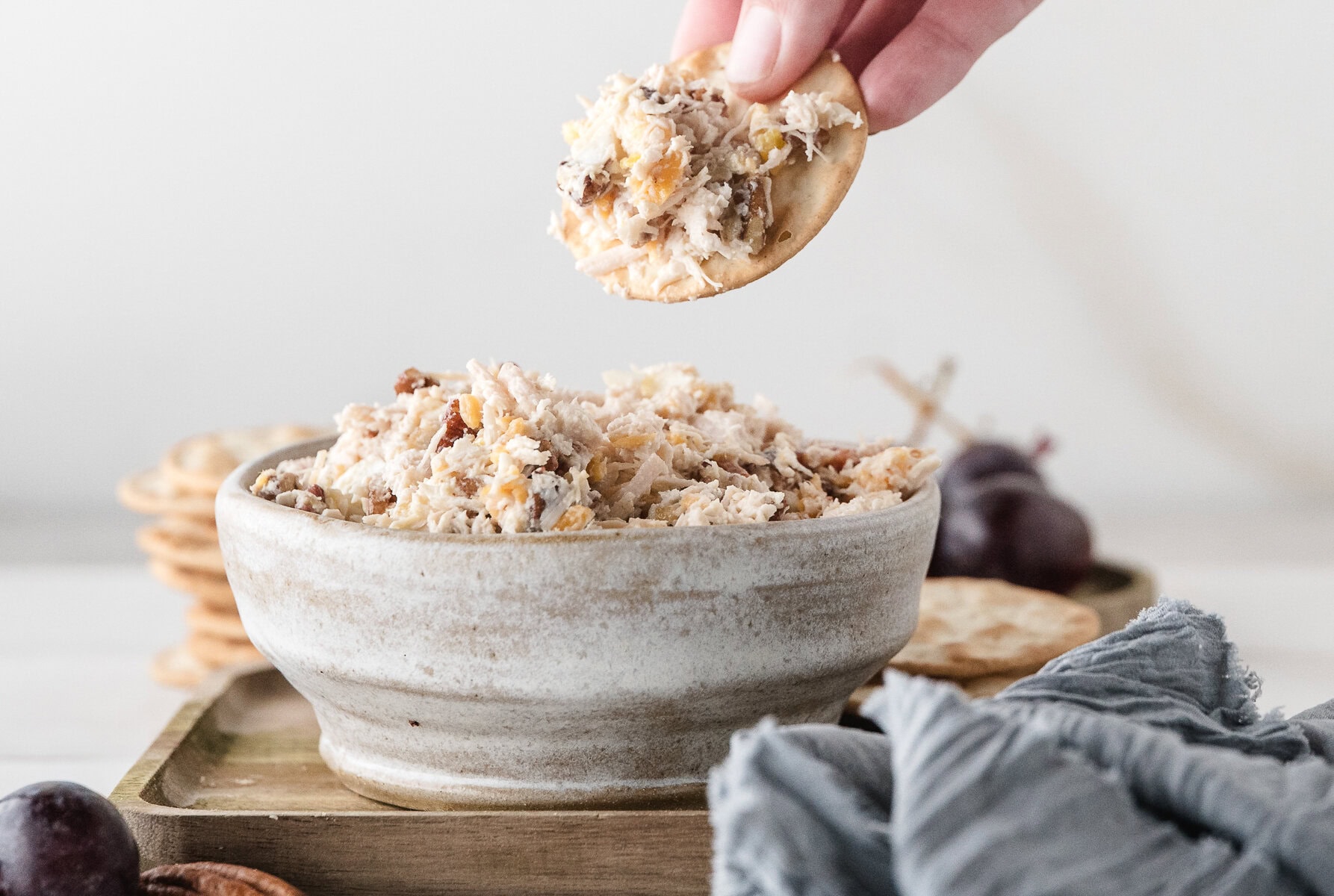 a bowl of the best canned chicken salad recipe with a cracker