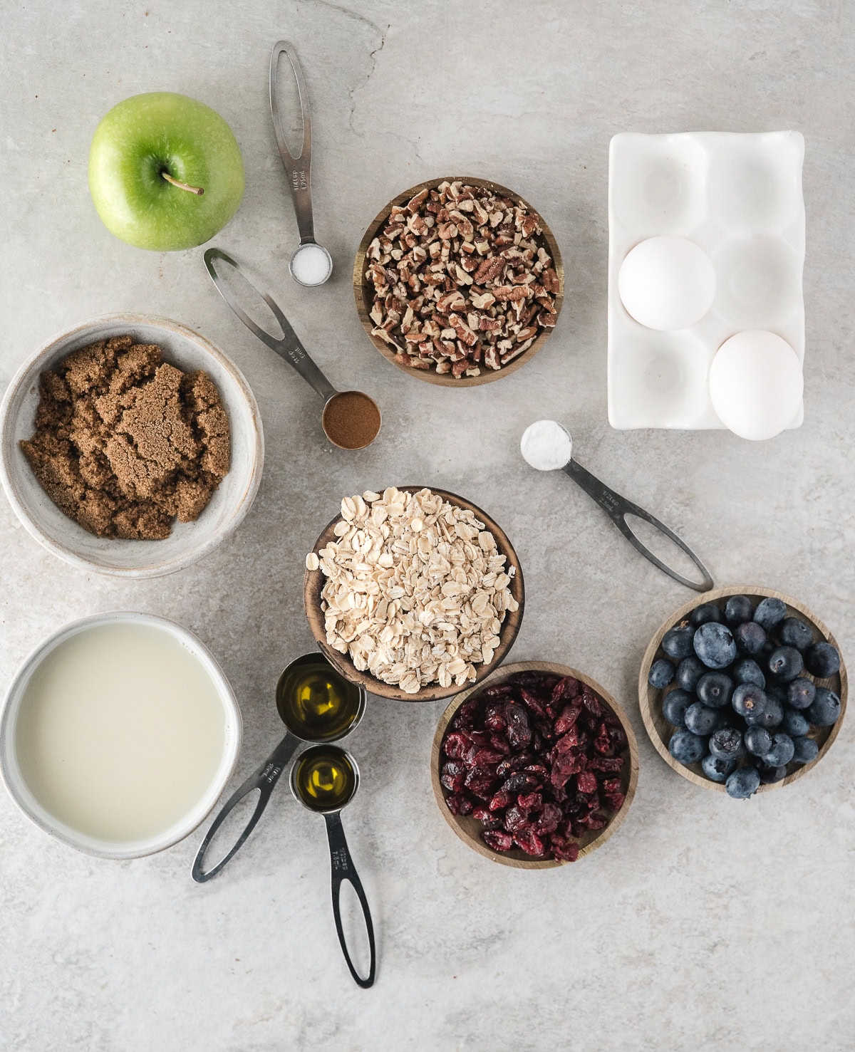 healthy baked oatmeal ingredients including blueberry, apple, and cherry