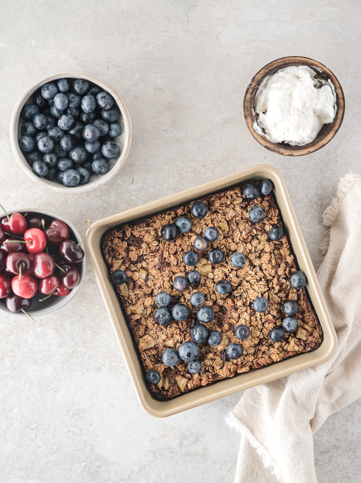 baked blueberry oatmeal with blueberries, cherries, and whipped topping