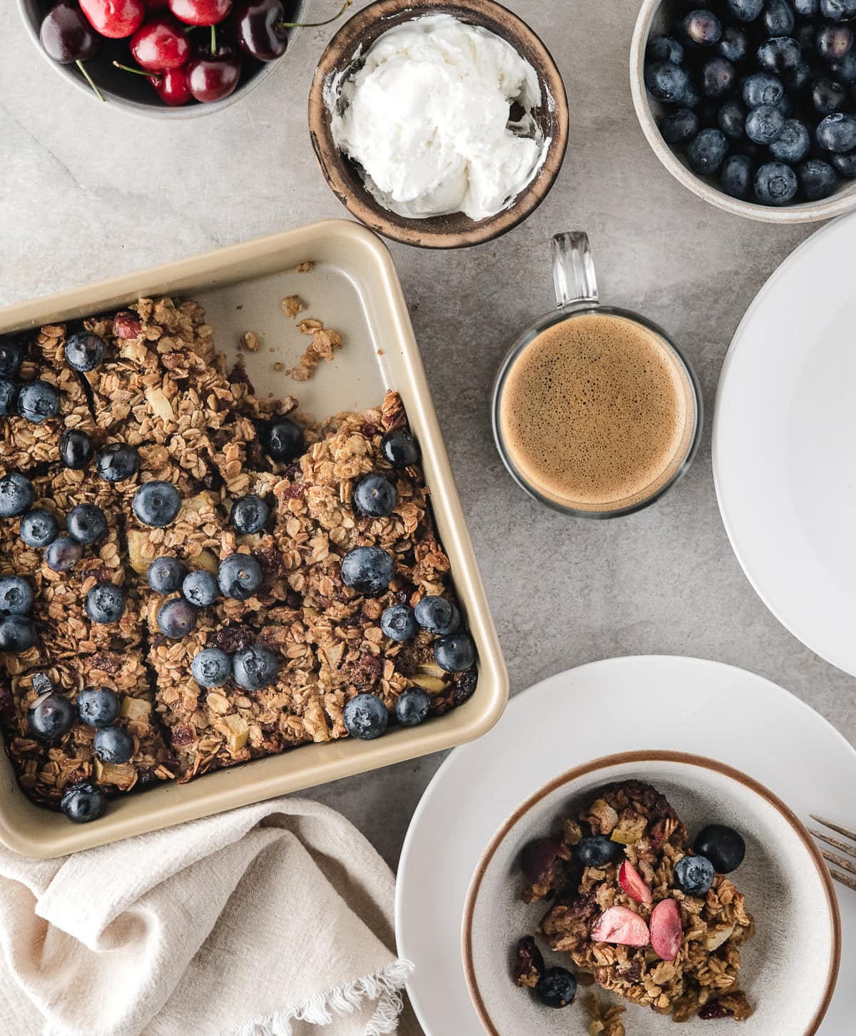 an easy homemade breakfast of baked oatmeal with fresh fruit and coffee