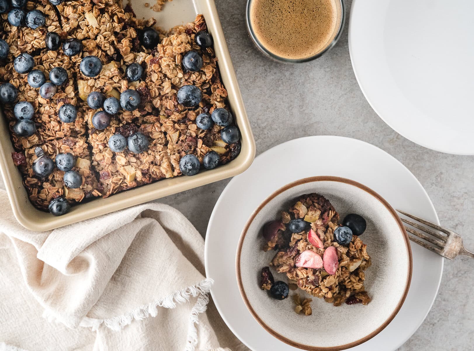 a healthy breakfast of baked oatmeal with blueberry, apple, and cherry