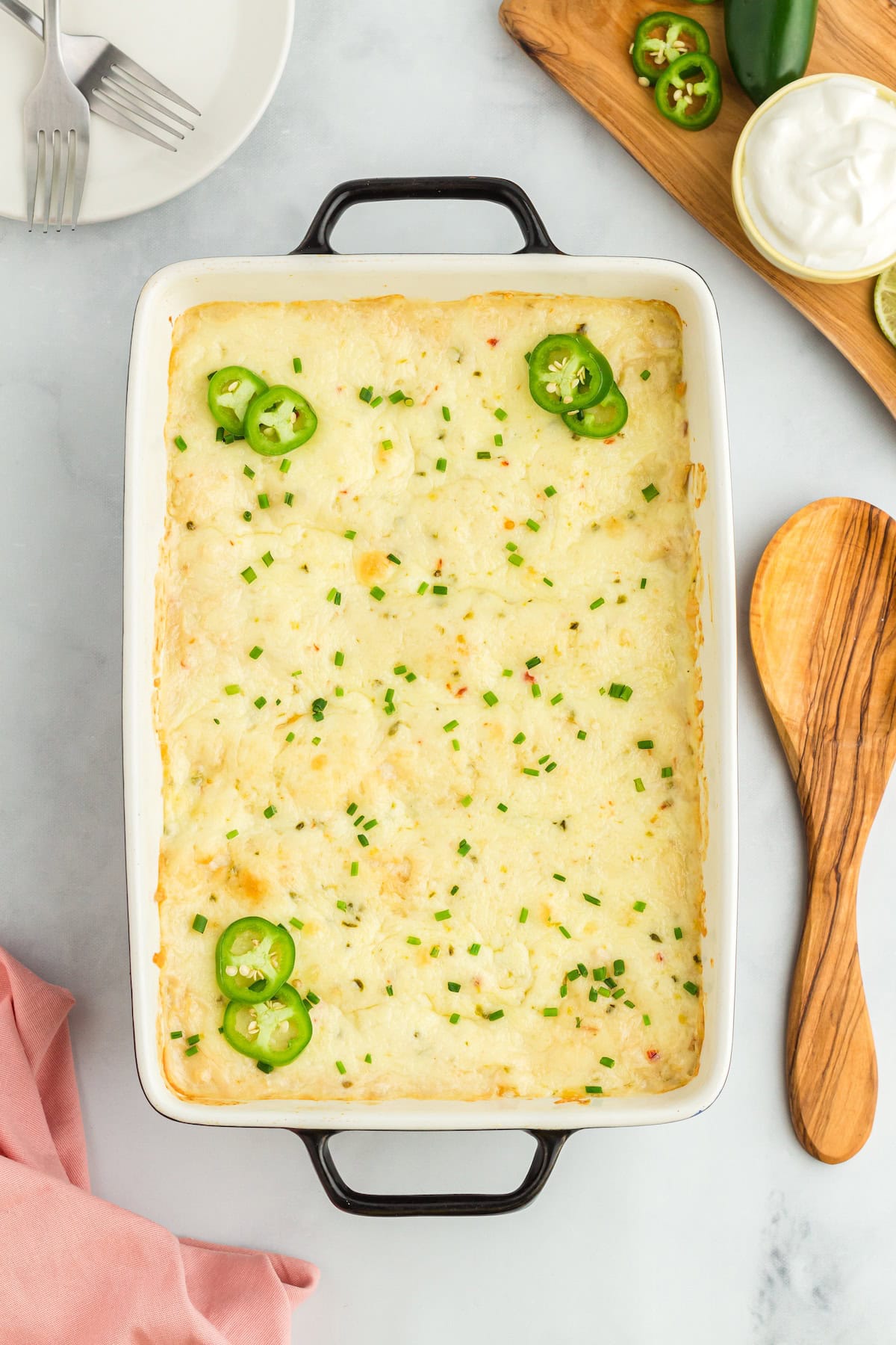 Creamy White Chicken Enchiladas with Cream of Chicken topped with chives and sliced jalapenos