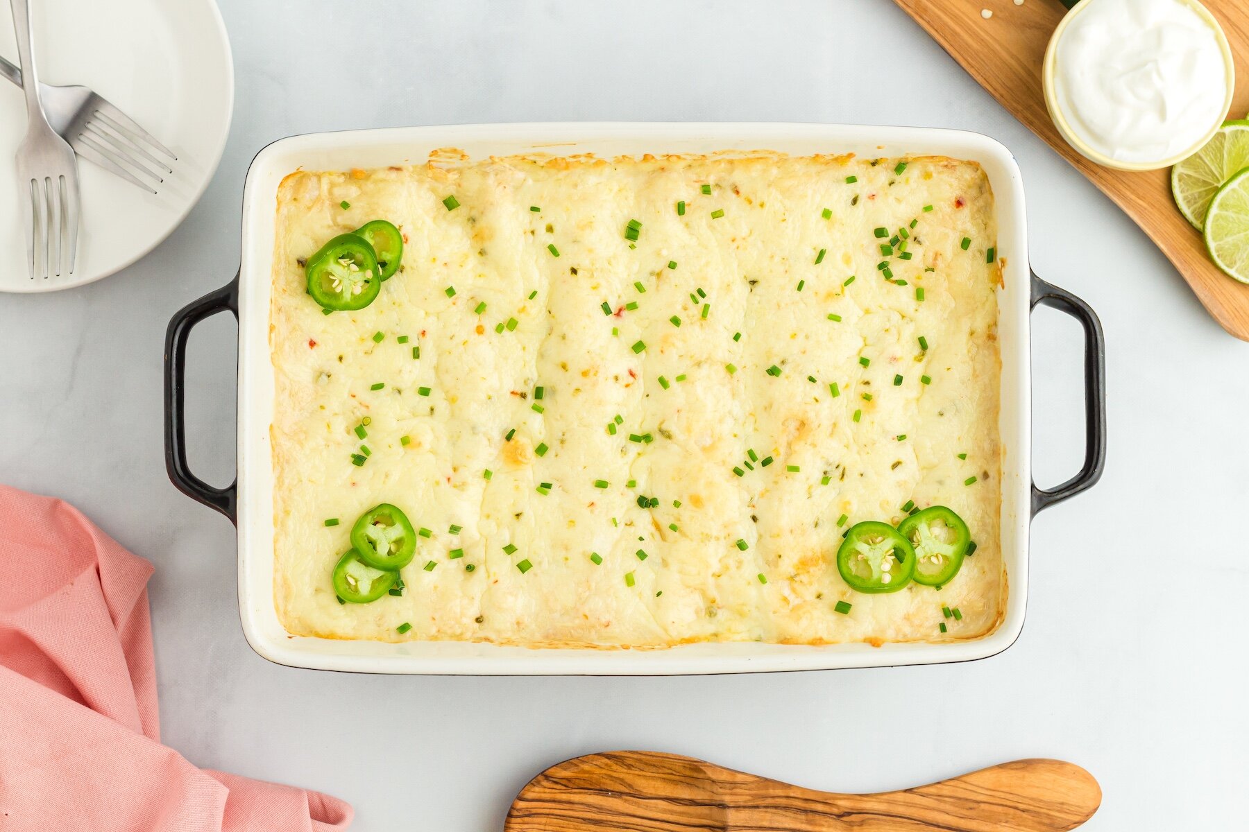 Creamy White Chicken Enchiladas with Cream of Chicken topped with sliced jalapenos and chives