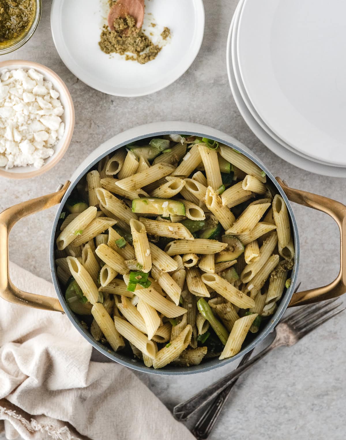 a large pot of easy pasta primavera with plates