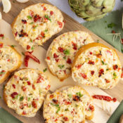 Artichoke Bruschetta with Sun-Dried Tomatoes on a cutting board