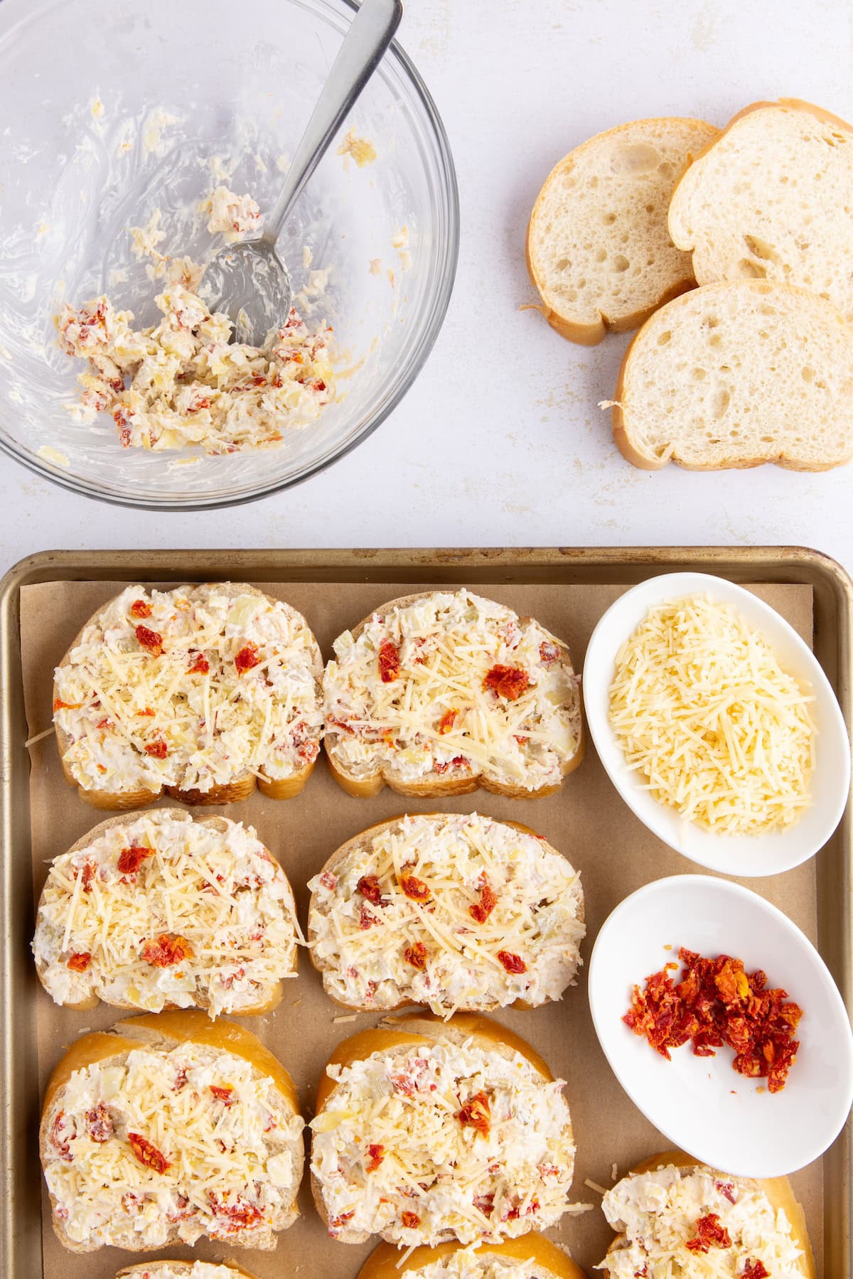 sprinkle the bruschetta with the reserved sun-dried tomatoes and Parmesan cheese