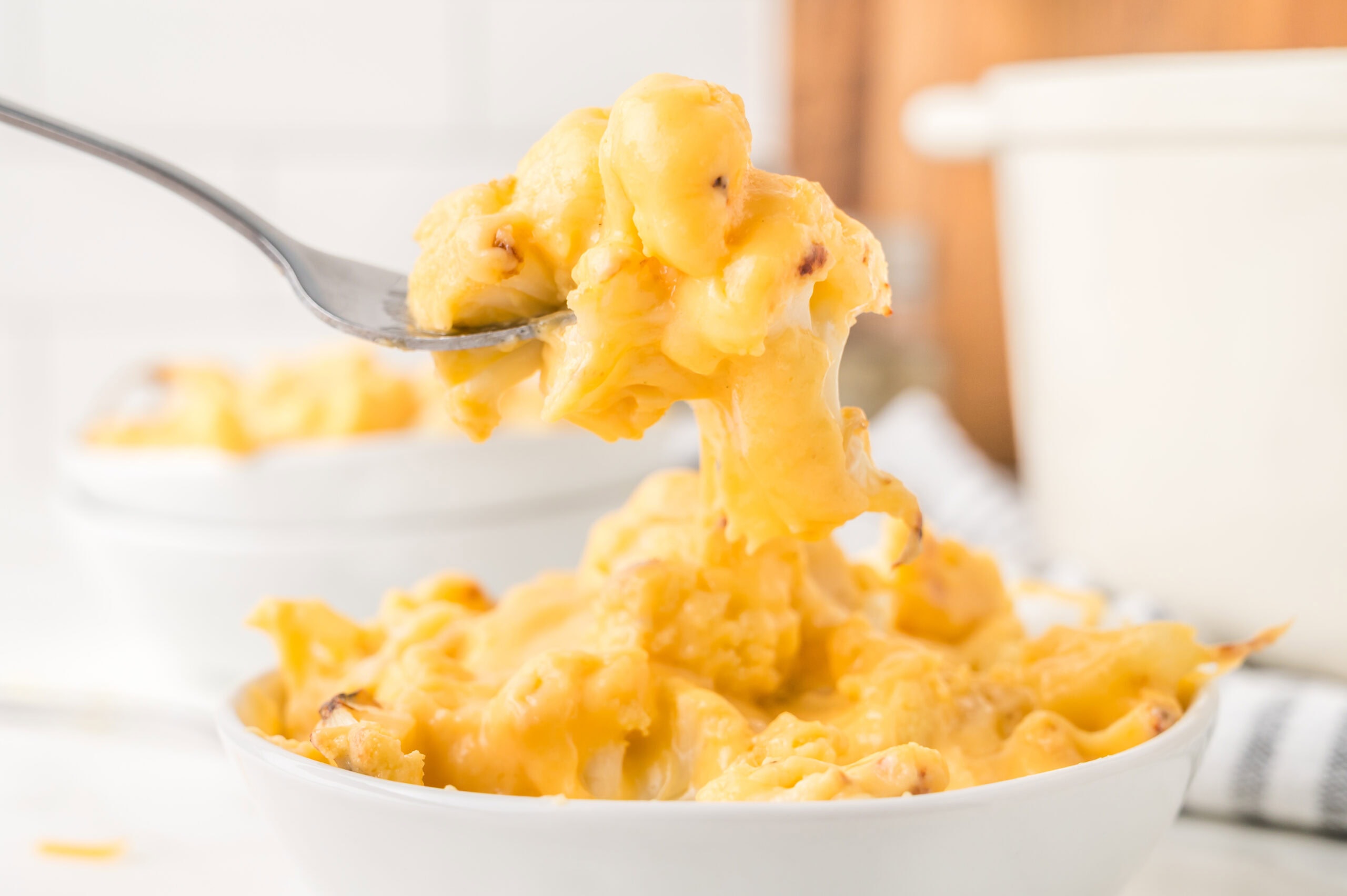Warm cauliflower mac & cheese picking up a perfect bite to eat