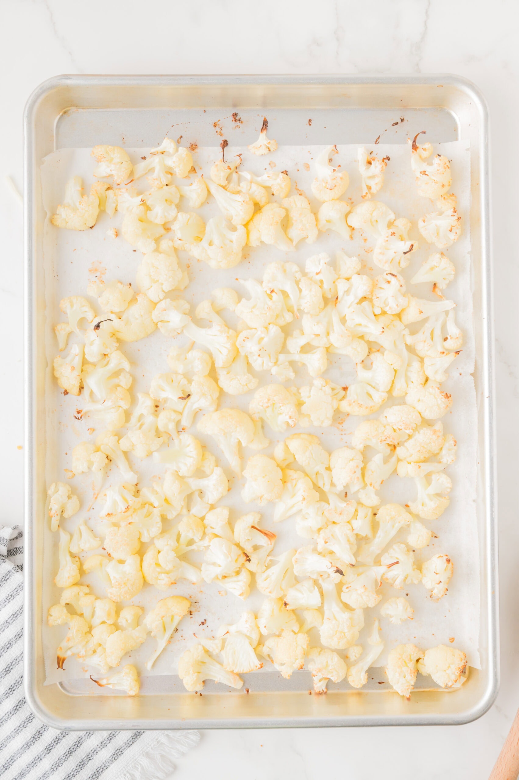 Cauliflower all baking in baking dish ready to be cooled and added to the homemade cheese sauce