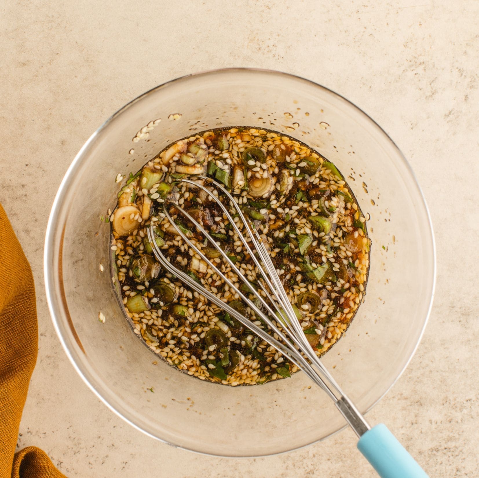 For this dumpling sauce with all its ingredients (for instance:soy sauce, ginger, green onion, sesame seeds,) and ready to be whisk to finalize the recipe