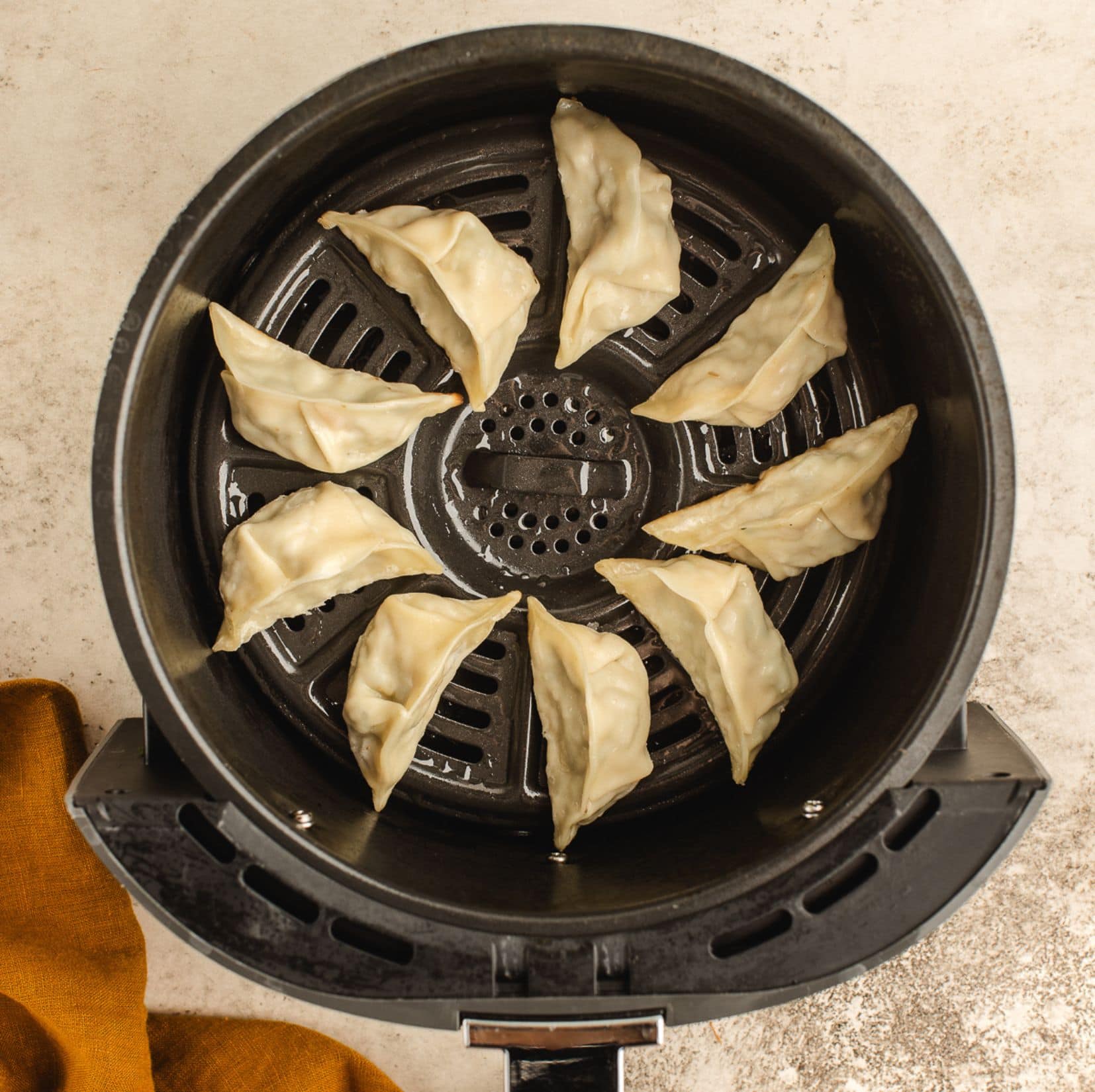 Dumplings placed in air fryer ready to be cooked.