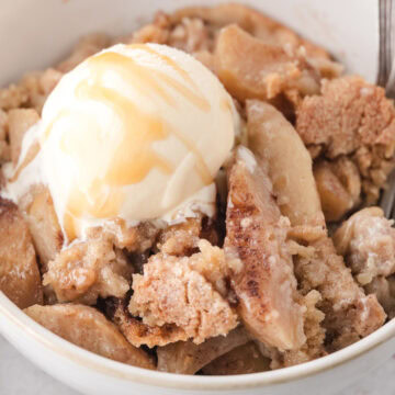 apple crisp without oats topped with homemade vanilla ice cream and caramel sauce