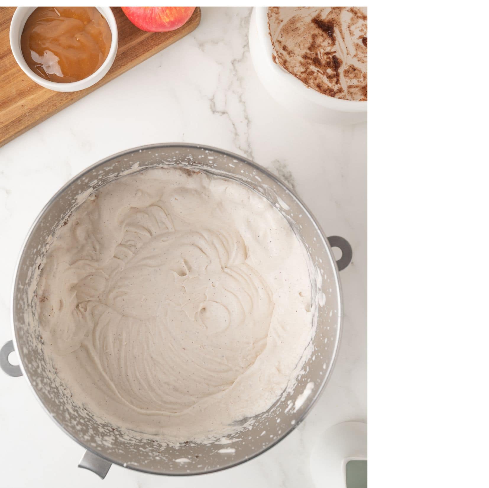 Large mixing bowl with wet ingredients all blended together to create the apple pie ice cream