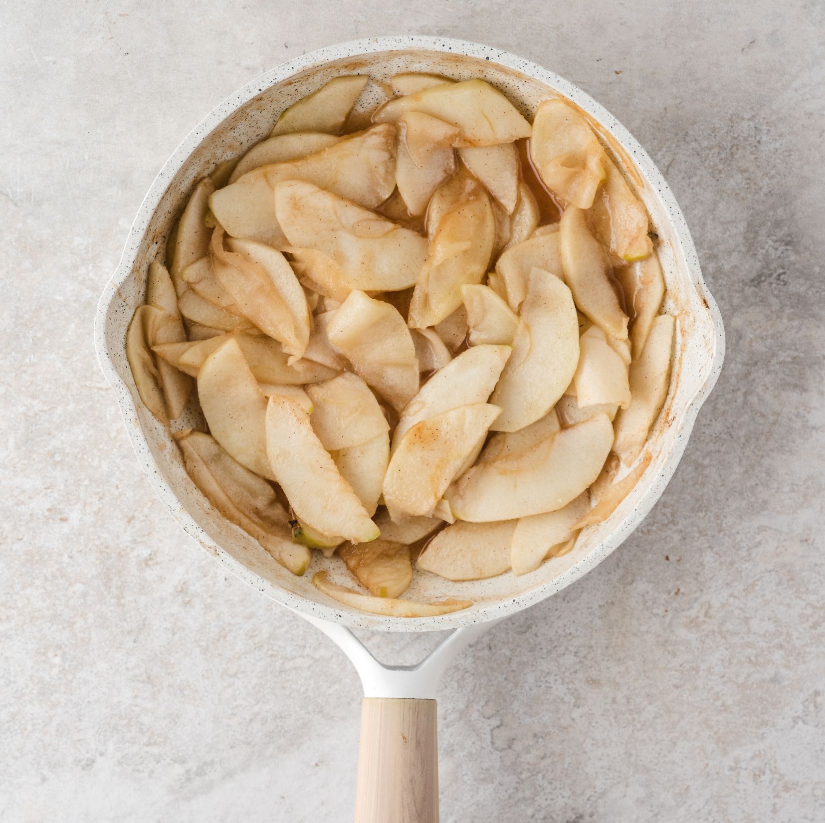 All apples cored and peeled with all ingredients mixed into the apples. They have been softened, ready to be added to the puff pastry