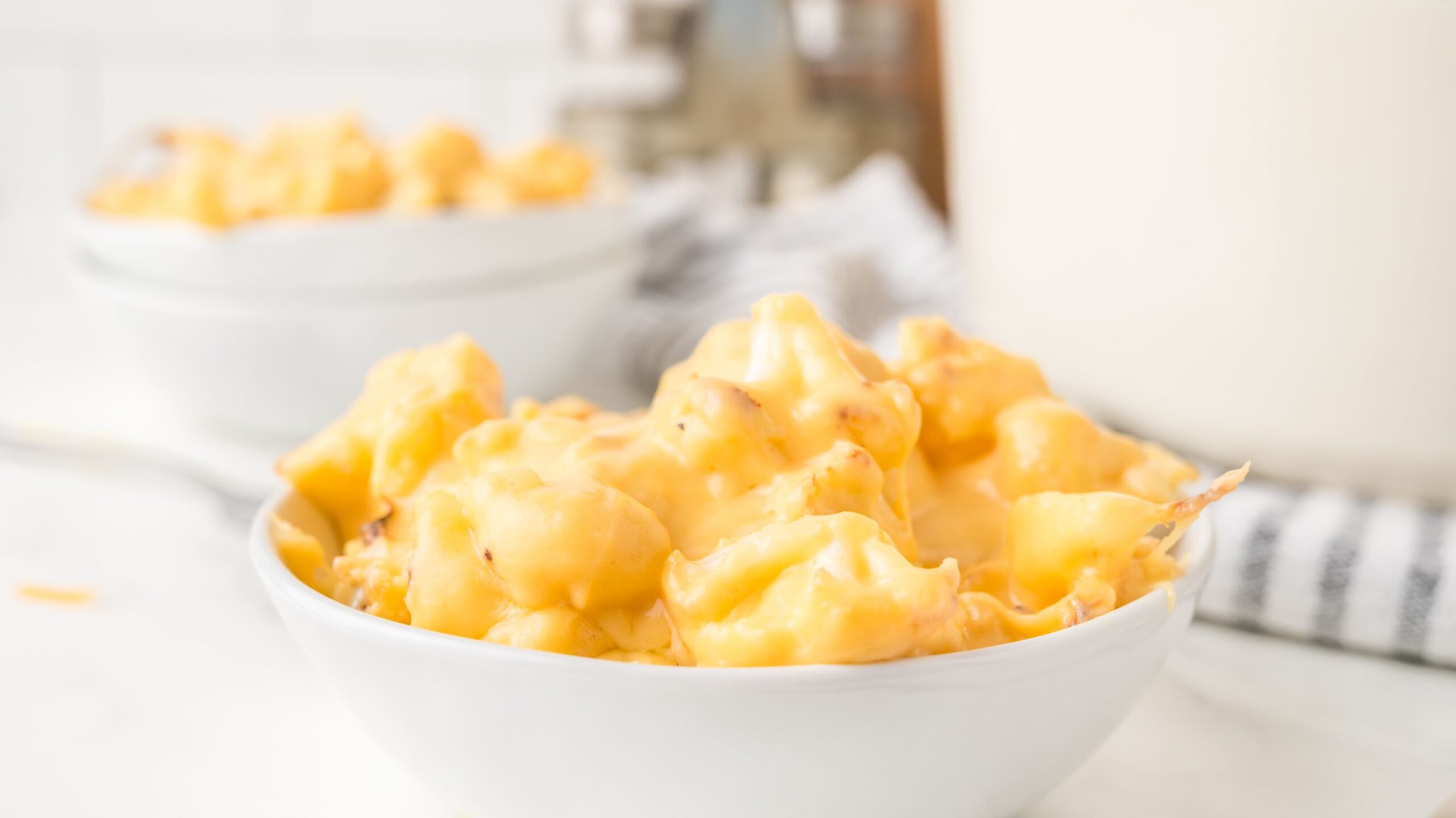 Cauliflower mac & cheese all warm and gooey served in a bowl