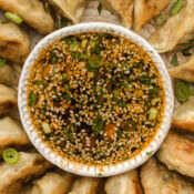 dumpling dipping sauce with air fryer potstickers around it