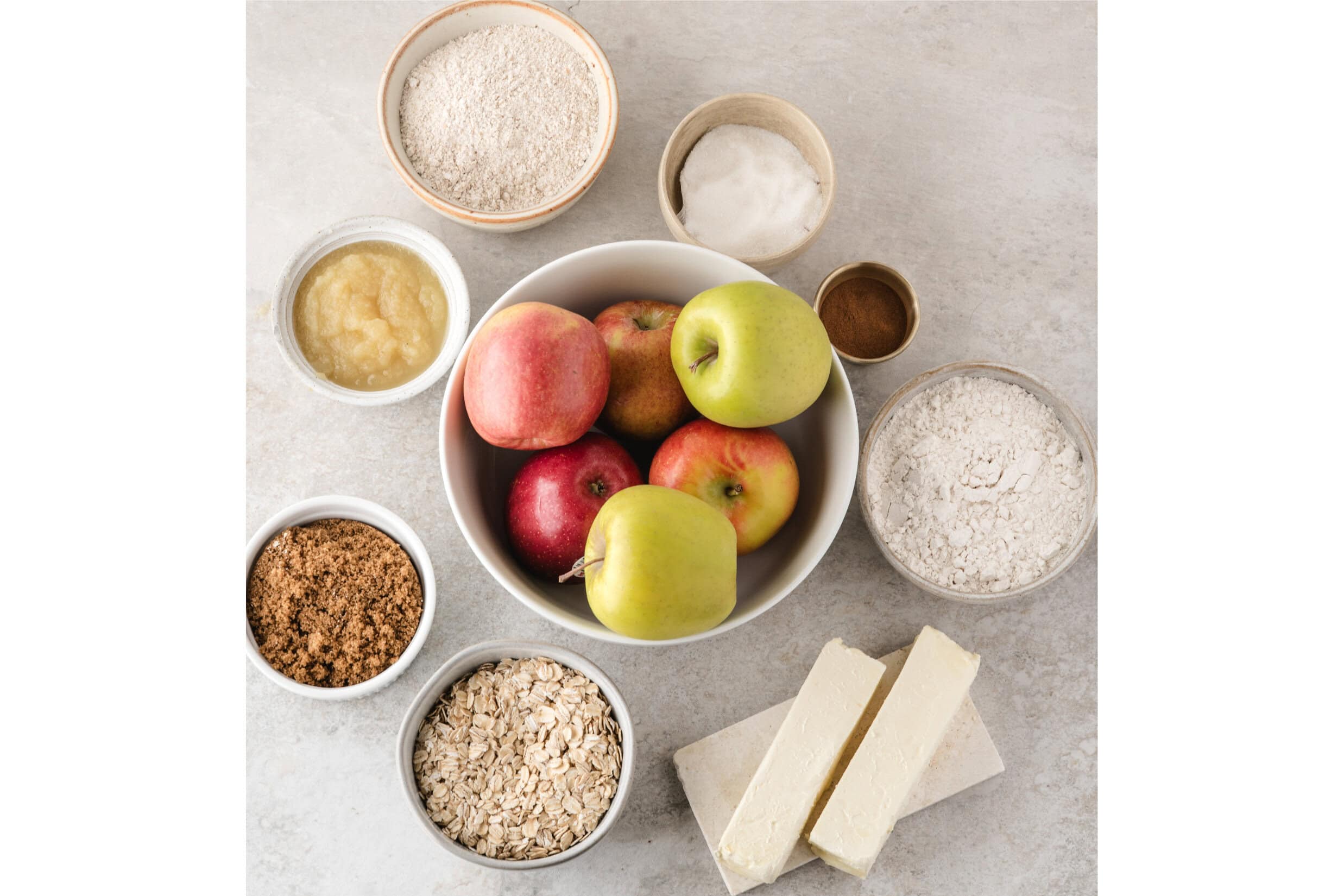 in this easy apple crisp with oats is all the ingredients shown: flour, applesauce, white sugar, oats, brown sugar, apple variations, cinnamon, butter