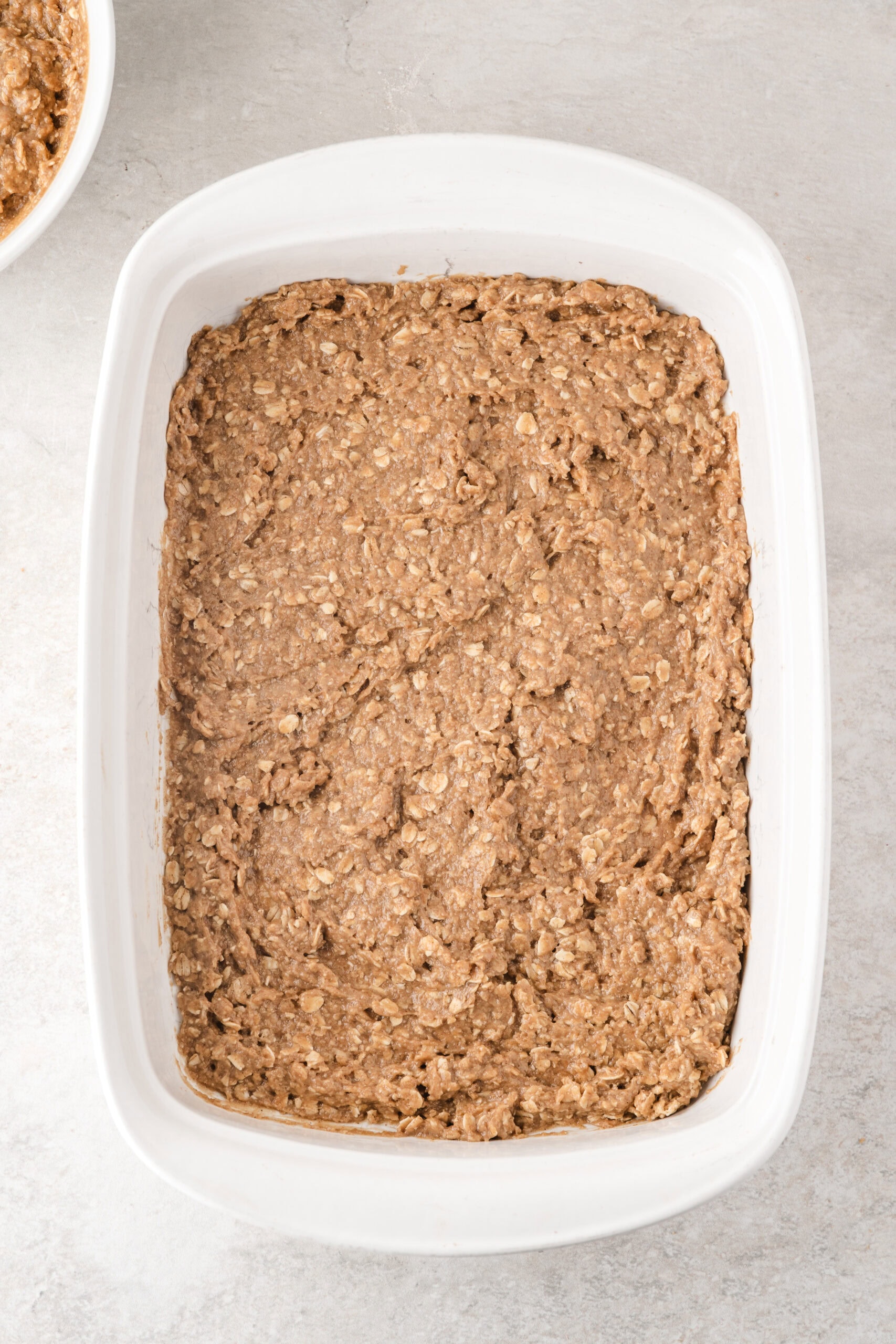 easy apple crisp is shown with the base of the dish which consists of the combined oat mixture, pressed to bottom of pan