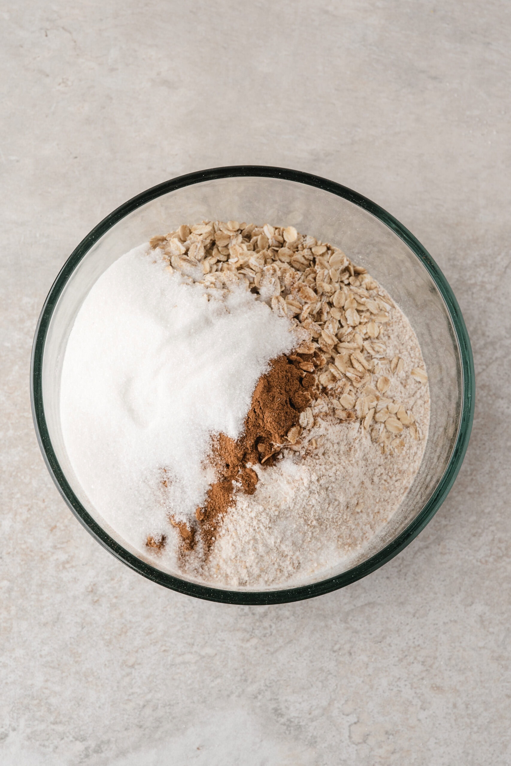 This apple crisp without oats has several dry ingredients. You mix in all purpose flour, whole wheat flour, rolled oats, cinnamon, and brown sugar.